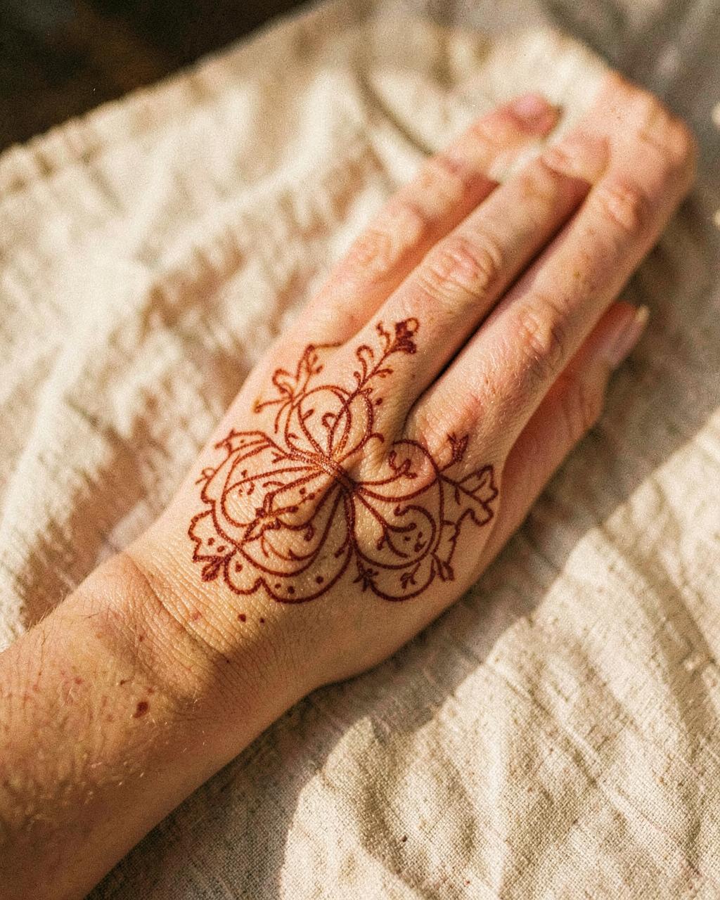Fine-line henna on a hand